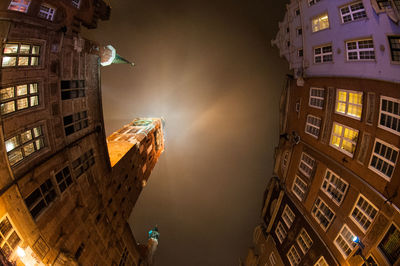Fish eye view of illuminated town hall against sky at night