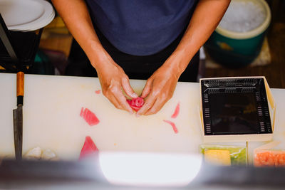 Midsection of man working on table