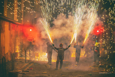 People watching firework display at night