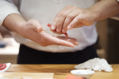 Midsection of woman preparing food