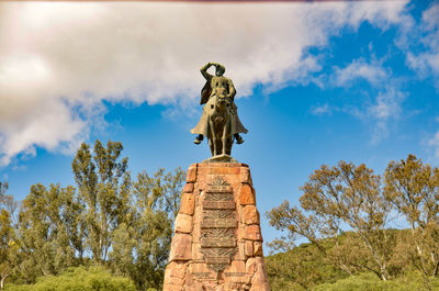 Low angle view of statue against blue sky