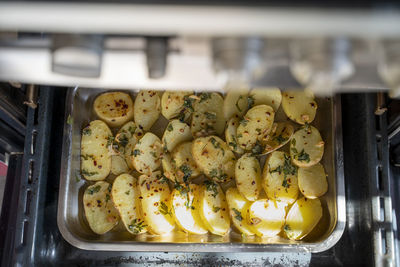 Oven roasted potatoes with garnished coriander in oven tray