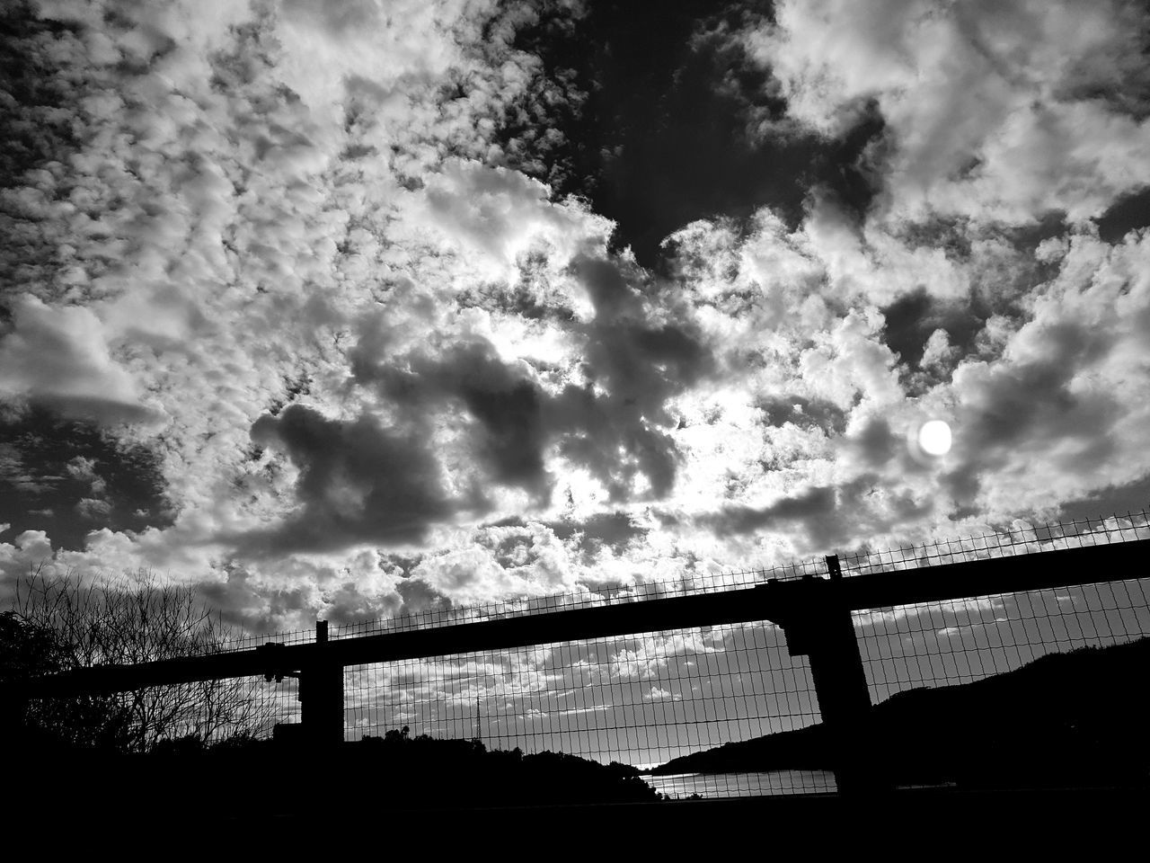 LOW ANGLE VIEW OF SILHOUETTE BRIDGE AGAINST SKY