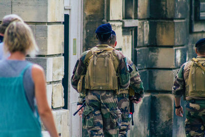 Rear view of soldier walking on street