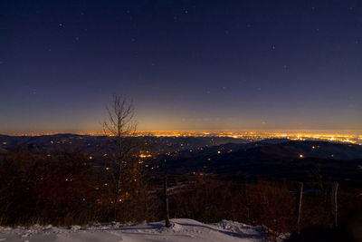Scenic view of landscape against sky at night