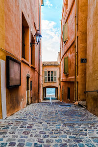 Alley amidst buildings against sky