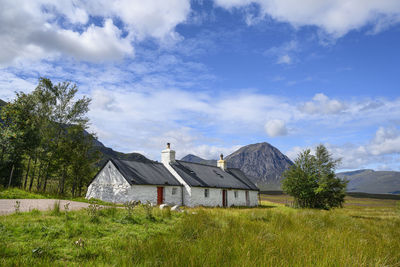 House on field against sky