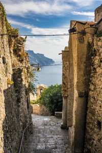 Street amidst old buildings against sky