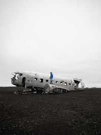 Man standing on abandoned airplane