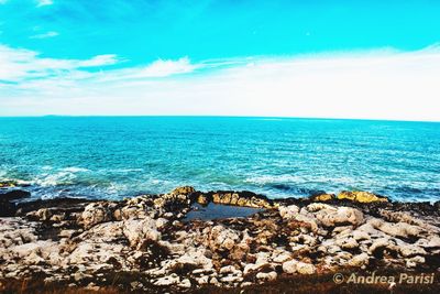 Scenic view of sea against blue sky