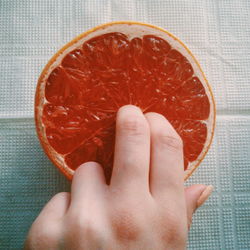 Close-up of hand holding grapefruit