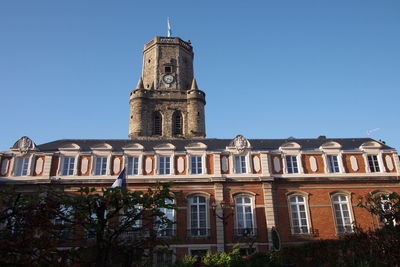 Low angle view of building against blue sky