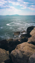 Scenic view of sea against cloudy sky