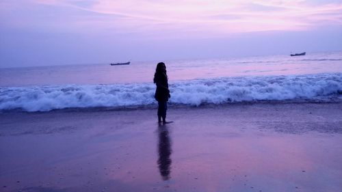 Man standing on beach against sky