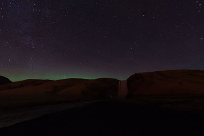 Scenic view of mountain against sky at night