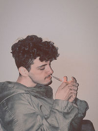 Portrait of young man smoking cigarette