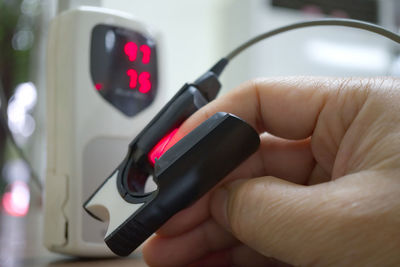 Close-up of hand holding smart phone in car