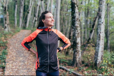 Young woman standing in forest