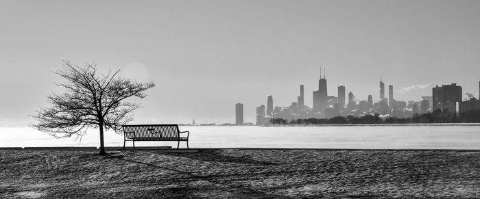 Frozen harbor in winter with big city skyline at dawn