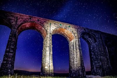 Low angle view of built structure against sky at night