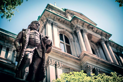 Low angle view of male statue at historic building