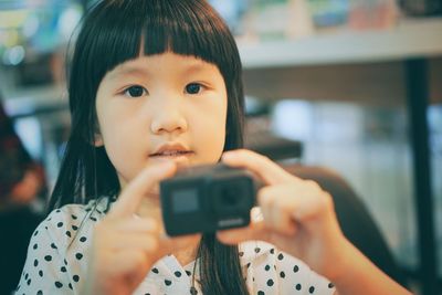 Portrait of boy photographing through smart phone