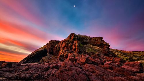 Scenic view of rocky mountains against sky during sunset