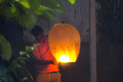 Close-up of illuminated yellow light at night