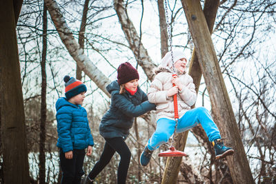 Full length of kids playing on the playground during winter