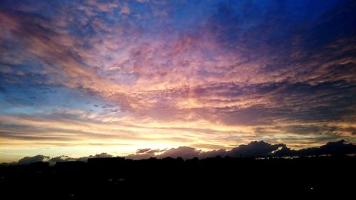 Silhouette of landscape against dramatic sky