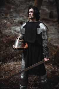 Close-up of young man wearing costume while standing on rock