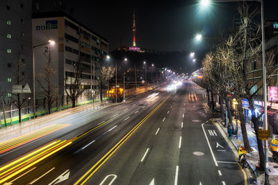 Light trails on road in city at night