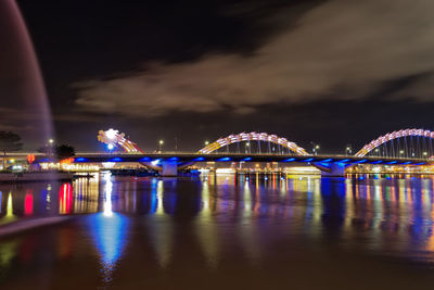 Illuminated dragon bridge over han river at night