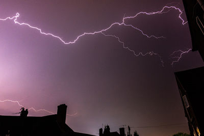 Low angle view of lightning in sky at night