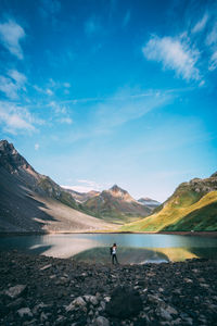 Scenic view of lake and mountains against sky