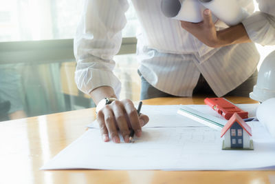 Low angle view of people working on table