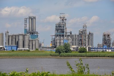 View of factory against cloudy sky