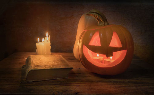 Close-up of lit candles on wooden table