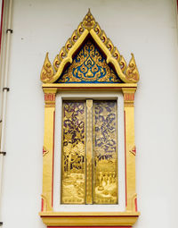 Close-up of ornate window on building wall