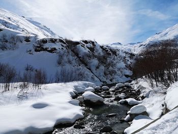 Scenic view of snowcapped mountains against sky