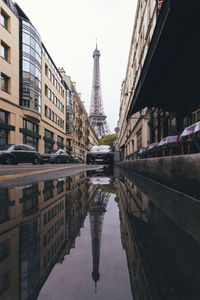 France, ile-de-france, paris, eiffel tower reflecting in street puddle