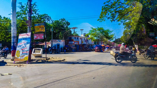 Cars on road in city against sky