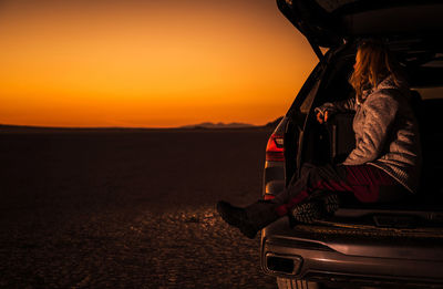 Tent on road against sky during sunset