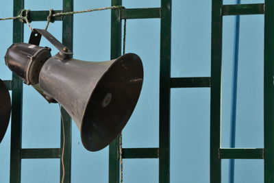 Close-up of old metal hanging against wall