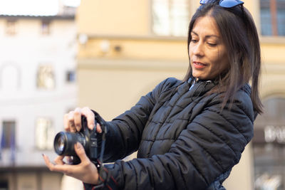Portrait of photographer woman unfocused background at florence, italy. 50mm lens