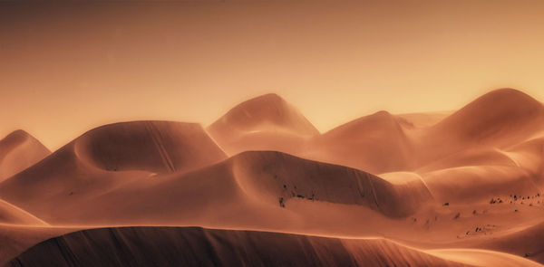 Close-up of sand against clear sky