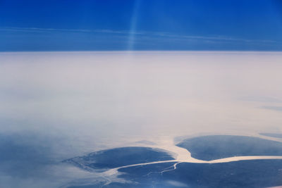 Aerial view of landscape against blue sky