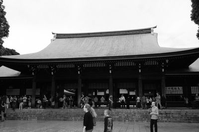 People at temple against sky