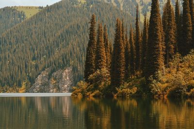 Idyllic shot of calm lake by mountain