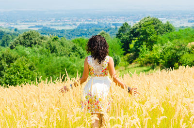 Rear view of woman in the field